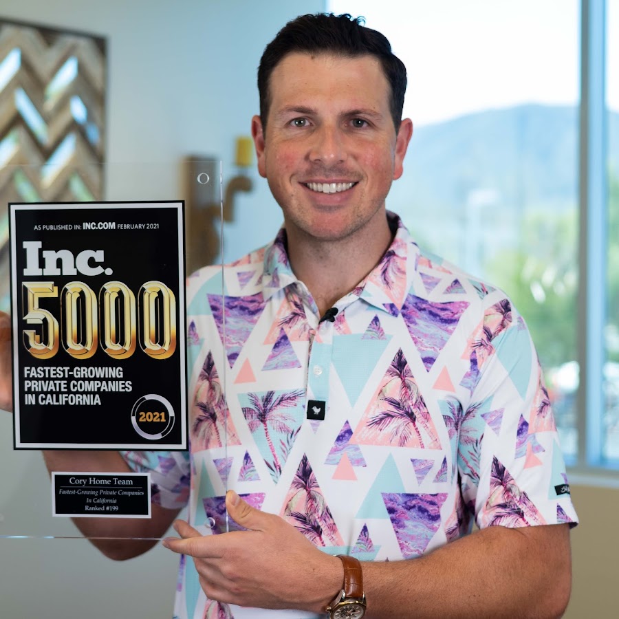 Blake Cory holding an Inc. 5000 award